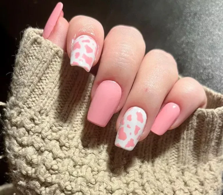Short square nails in bubblegum pink with white cow print accent nails